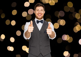 Image showing happy man in festive suit pointing in camera