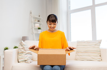 Image showing happy asian young woman with parcel box at home