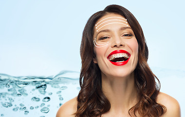 Image showing beautiful laughing woman with face lifting arrows