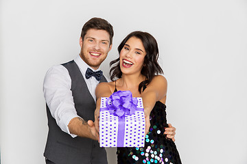 Image showing happy couple with gift box at birthday party