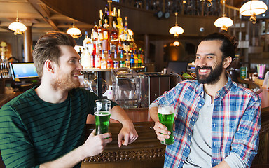 Image showing male friends drinking green beer at bar or pub