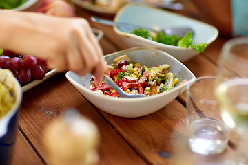 Image showing people eating salad at table with food