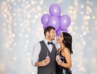 Image showing happy couple with balloons and cupcakes at party