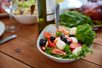 Image showing vegetable salad with mozzarella on wooden table