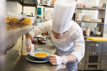 Image showing happy male chef cooking food at restaurant kitchen