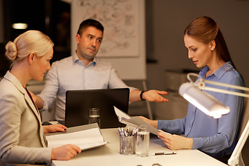 Image showing business team with laptop working late at office