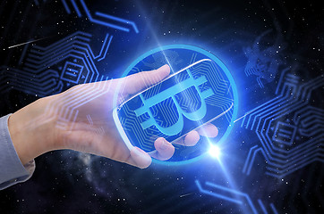 Image showing close up of hand with smartphone and bitcoin