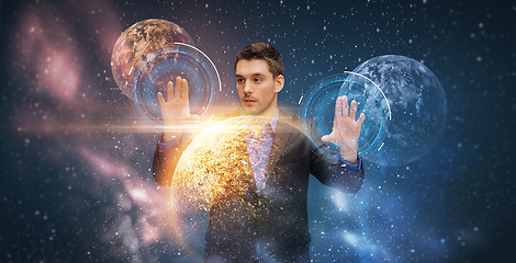 Image showing businessman with virtual planets and space