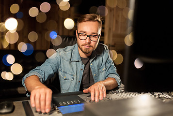 Image showing man at mixing console in music recording studio