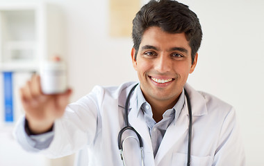 Image showing happy doctor with stethoscope and medication