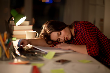 Image showing student or woman sleeping on table at night home