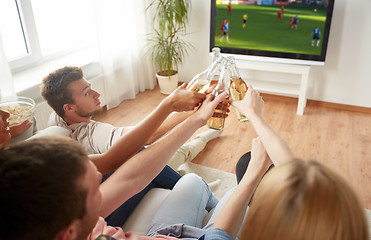 Image showing friends clinking beer and watching soccer game