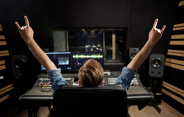 Image showing man at mixing console in music recording studio