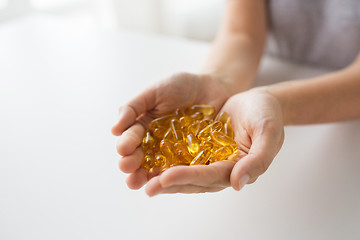 Image showing hands holding cod liver oil capsules