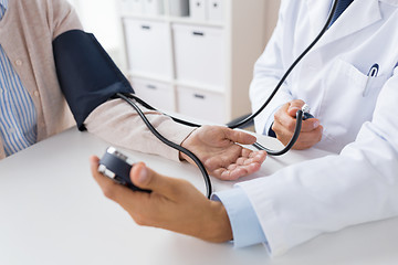 Image showing doctor with tonometer and senior woman at hospital