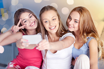 Image showing teen girls with smartphone taking selfie at home