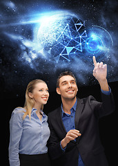 Image showing businessman and businesswoman over space