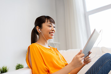 Image showing happy asian woman with tablet pc and earphones