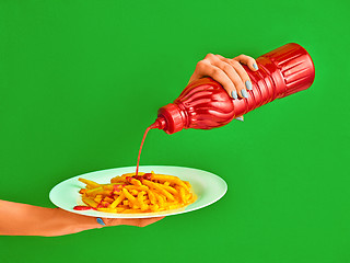 Image showing Young woman with plate of french fries potato with ketchup