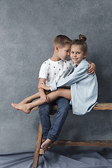 Image showing A portrait of little girl and a boy on the gray background