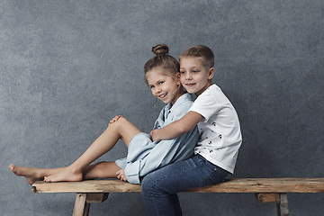 Image showing A portrait of little girl and a boy on the gray background