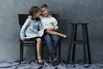 Image showing A portrait of little girl and a boy on the gray background