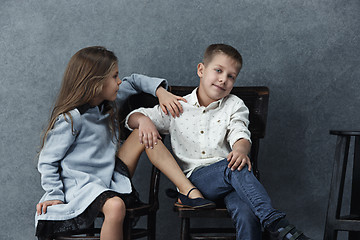 Image showing A portrait of little girl and a boy on the gray background