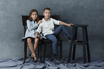 Image showing A portrait of little girl and a boy on the gray background