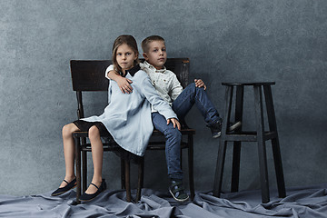 Image showing A portrait of little girl and a boy on the gray background