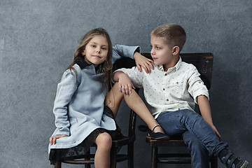 Image showing A portrait of little girl and a boy on the gray background