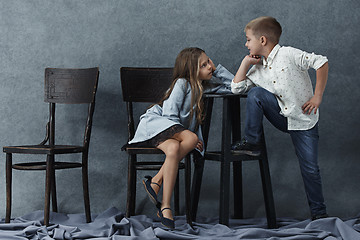 Image showing A portrait of little girl and a boy on the gray background