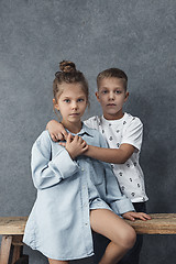 Image showing A portrait of little girl and a boy on the gray background