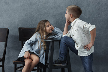 Image showing A portrait of little girl and a boy on the gray background