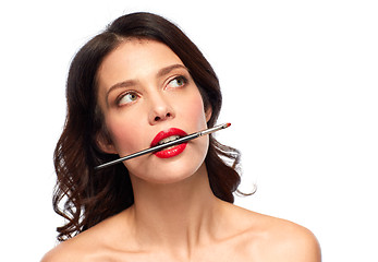 Image showing beautiful woman holding make up brush for lipstick