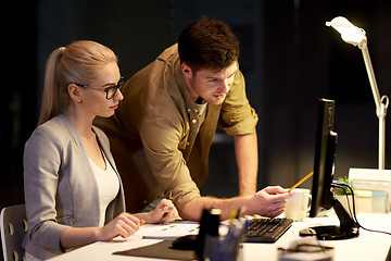 Image showing business team with computer working late at office