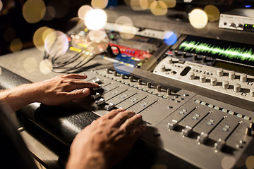 Image showing man using mixing console in music recording studio