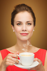 Image showing beautiful woman in red dress with cup of coffee