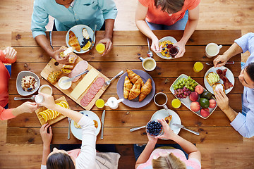 Image showing group of people having breakfast at table