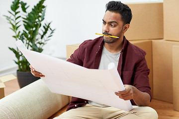 Image showing man with blueprint and boxes moving to new home