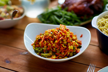 Image showing vegetable salad in bowl on wooden table