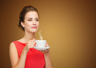 Image showing beautiful woman in red dress with cup of coffee