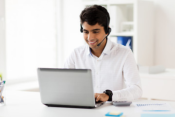 Image showing businessman with headset and laptop at office