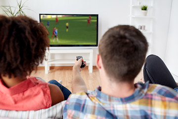 Image showing friends watching soccer game on tv at home