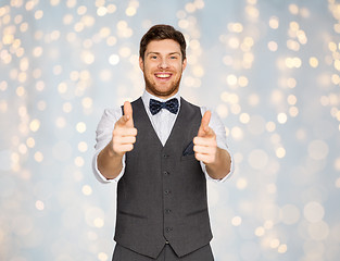 Image showing happy man in festive suit pointing in camera