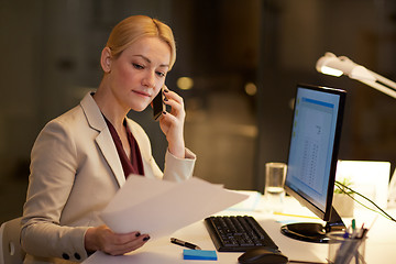 Image showing businesswoman calling on smartphone at office