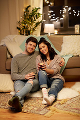 Image showing happy couple drinking coffee and eating at home