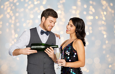 Image showing happy couple with champagne and glass at party