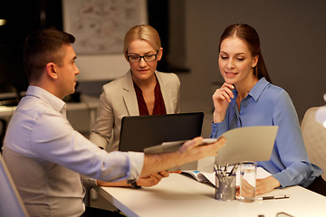 Image showing business team with papers working late at office