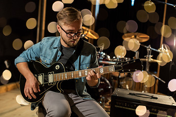 Image showing man playing guitar at studio rehearsal