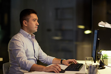 Image showing businessman with computer working at night office